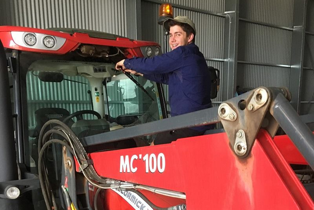 Man working on a MC'100 Mccormick Tractor
